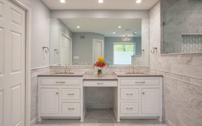 remodeled bathroom with white cabinets and gold faucets